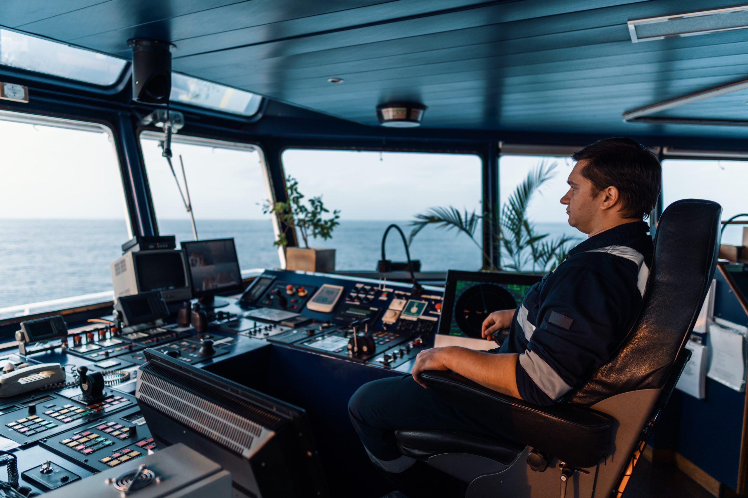 Marine navigational officer during navigational watch on Bridge . Work at sea